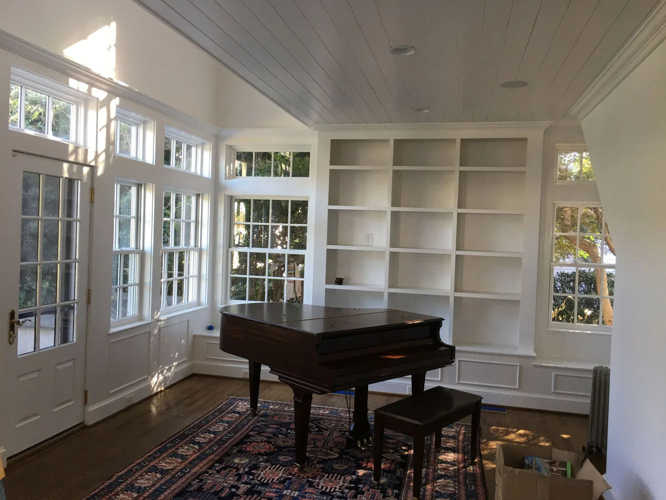 Piano room with freshly painted bookshelves
