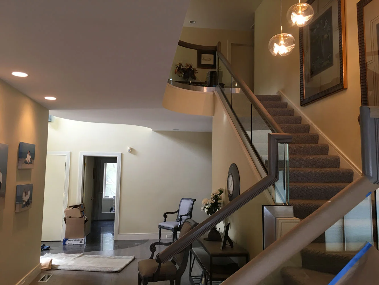 Foyer staircase with modern glass railings