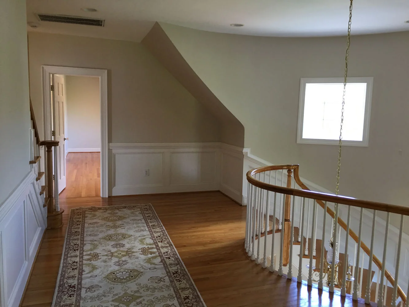 Painted staircase hallway with wainscoting