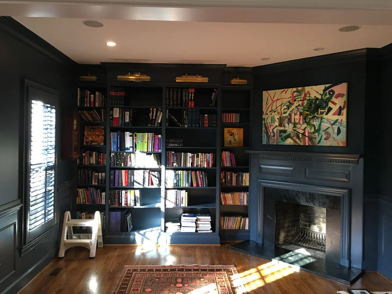 Dark navy library study with fireplace