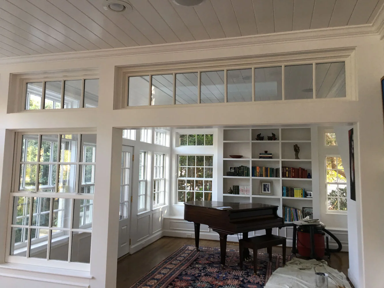 Music room with piano and bookshelves